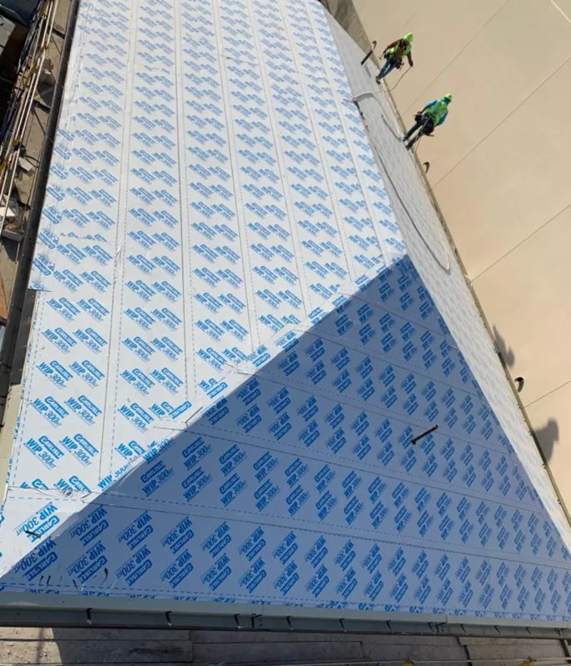 Professional roofers installing underlayment on a metal roof in Commerce